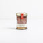 A small glass jar of Tuscan Truffle Honey with a gold lid and a metallic label, centered against a seamless white background.